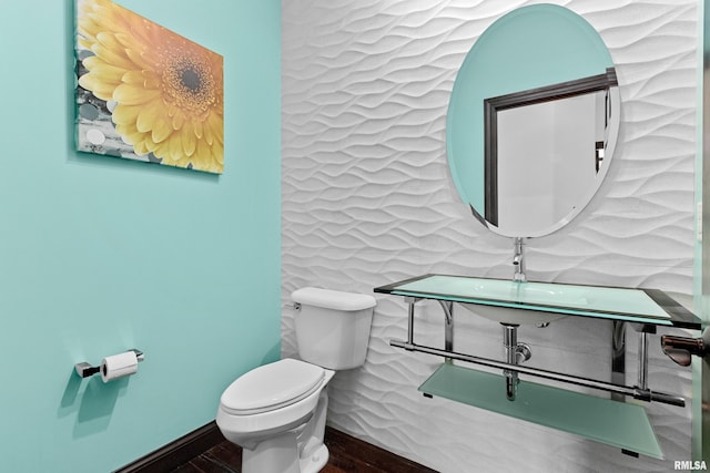 bathroom featuring wood finished floors and toilet