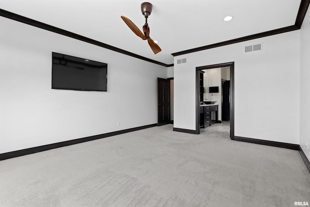 unfurnished room with visible vents, baseboards, light colored carpet, and crown molding