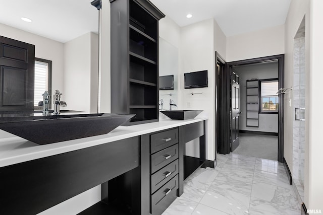 bathroom featuring a wealth of natural light, a sink, and double vanity