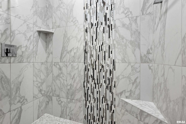 full bathroom with a tile shower