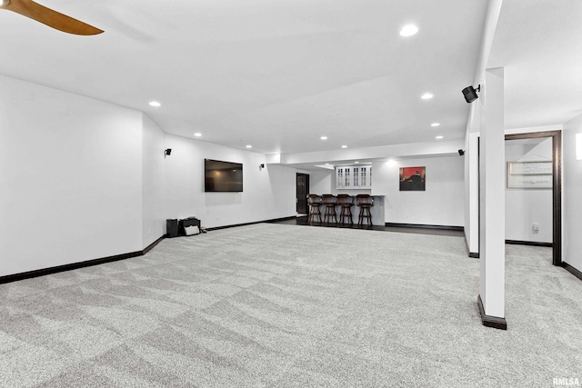 basement with bar, recessed lighting, and carpet