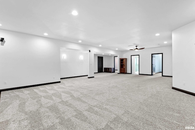 carpeted empty room featuring ceiling fan, baseboards, and recessed lighting