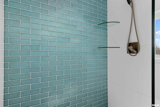 interior details featuring tiled shower