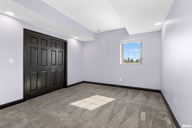 spare room featuring baseboards, carpet floors, and recessed lighting