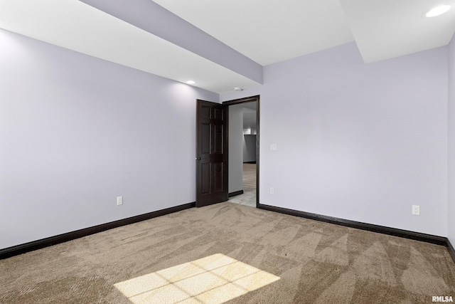 spare room featuring recessed lighting, baseboards, and light carpet
