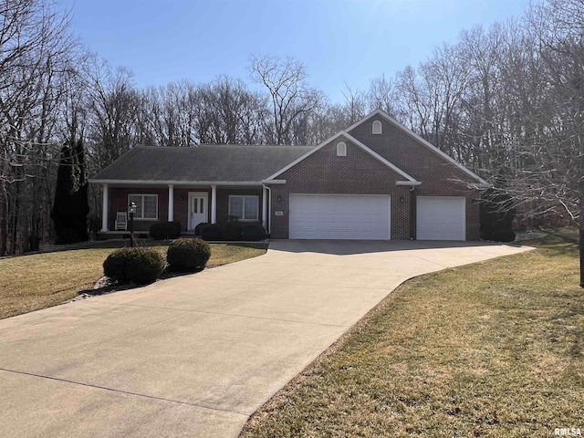 ranch-style home with brick siding, concrete driveway, covered porch, a front yard, and a garage