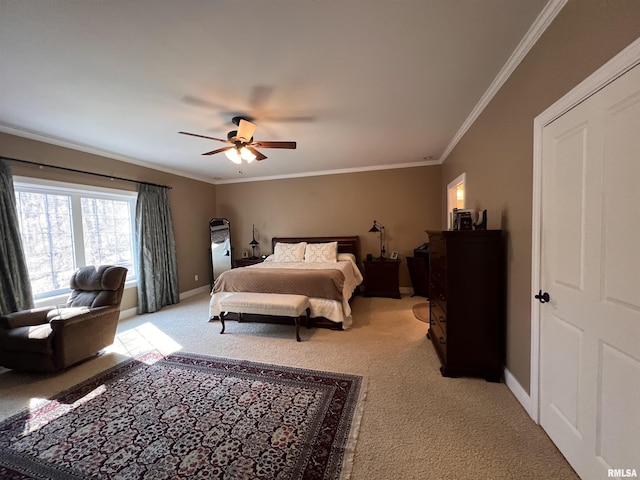 bedroom featuring baseboards, ornamental molding, ceiling fan, and light colored carpet