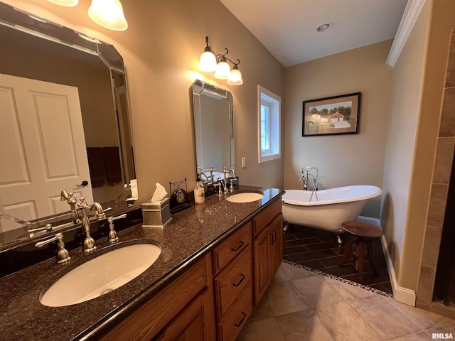 bathroom featuring tile patterned flooring, a sink, a freestanding bath, and double vanity