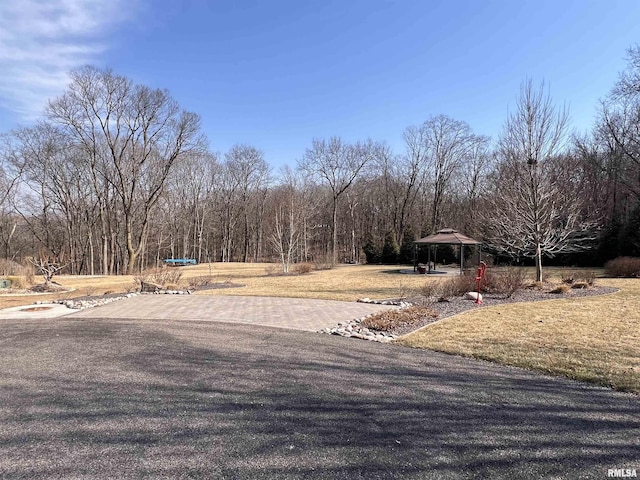 view of yard with a wooded view and a gazebo