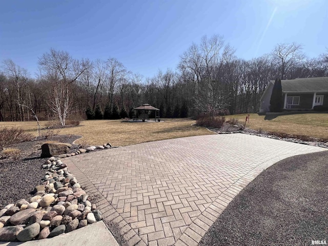 view of patio / terrace featuring decorative driveway and a gazebo