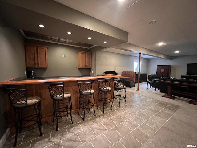 bar featuring wet bar, light carpet, and recessed lighting