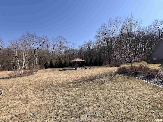 view of yard with a view of trees and a gazebo