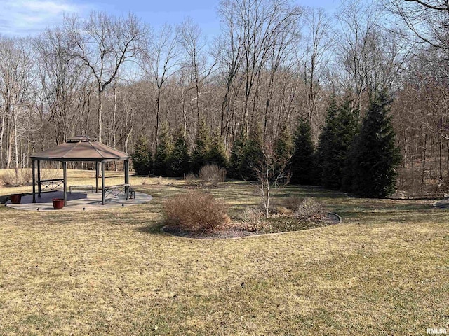 view of yard with a view of trees and a gazebo