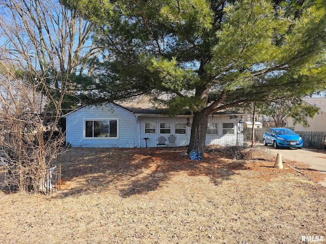 ranch-style home with fence