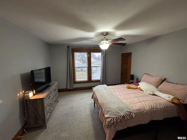 bedroom featuring light carpet, ceiling fan, and baseboards