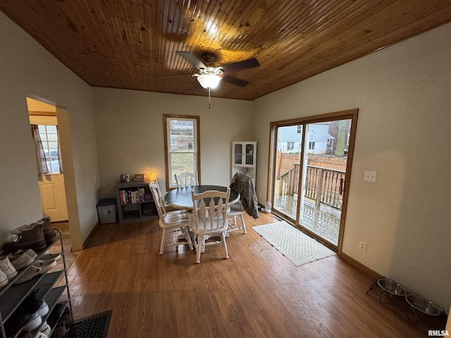 dining area with arched walkways, ceiling fan, wooden ceiling, and wood finished floors