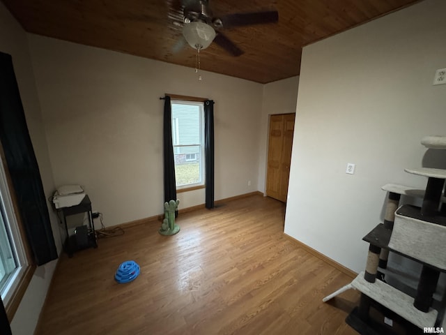 interior space featuring wooden ceiling, ceiling fan, baseboards, and wood finished floors