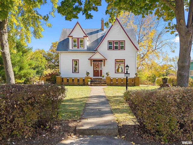 view of front of property featuring a front yard and a chimney