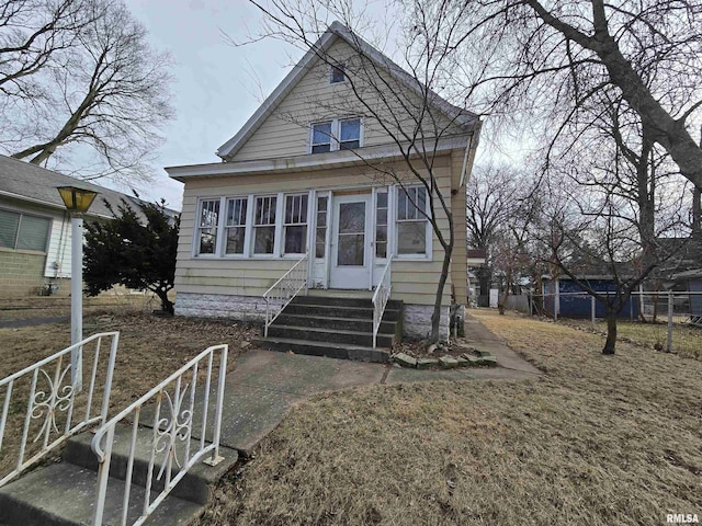 view of front of house with entry steps and fence