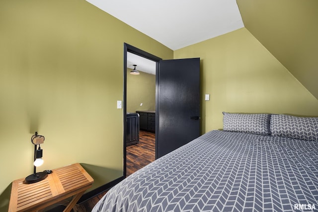 bedroom featuring vaulted ceiling and wood finished floors