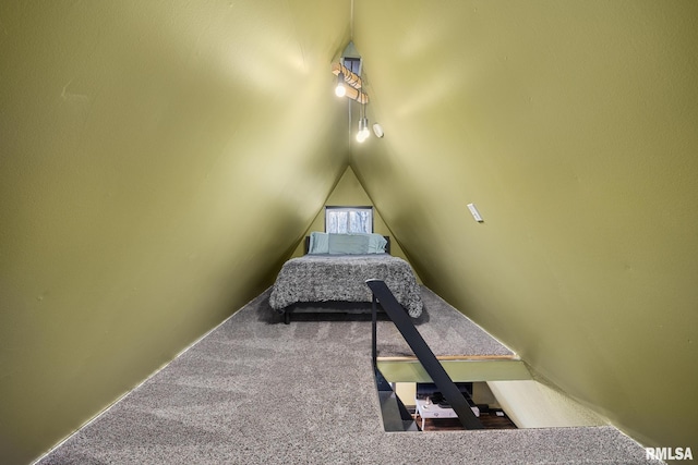 carpeted bedroom with lofted ceiling