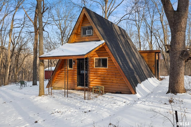 a-frame style home featuring a garage and a shingled roof