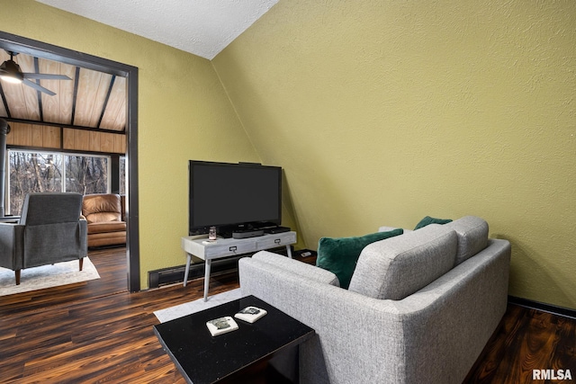 living room with a ceiling fan, lofted ceiling, a textured wall, and wood finished floors