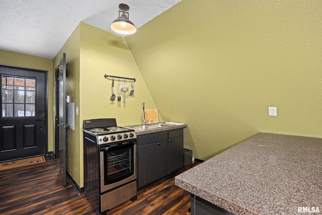 kitchen featuring dark wood finished floors, a textured wall, stainless steel electric range, a textured ceiling, and a sink