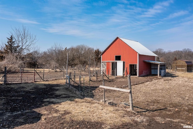 view of pole building featuring fence