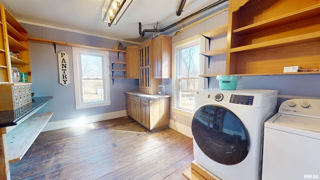 clothes washing area with washing machine and dryer and light wood-style floors