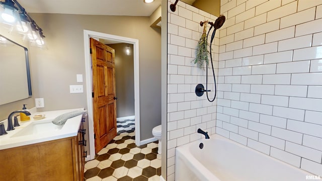 bathroom featuring bathtub / shower combination, vanity, and toilet