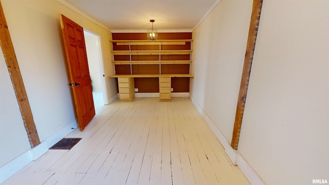 corridor with baseboards, visible vents, crown molding, and hardwood / wood-style floors