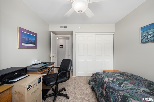 carpeted bedroom featuring a ceiling fan, a closet, and visible vents