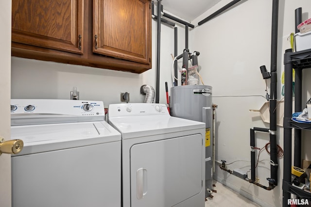 washroom with cabinet space, washing machine and dryer, and electric water heater