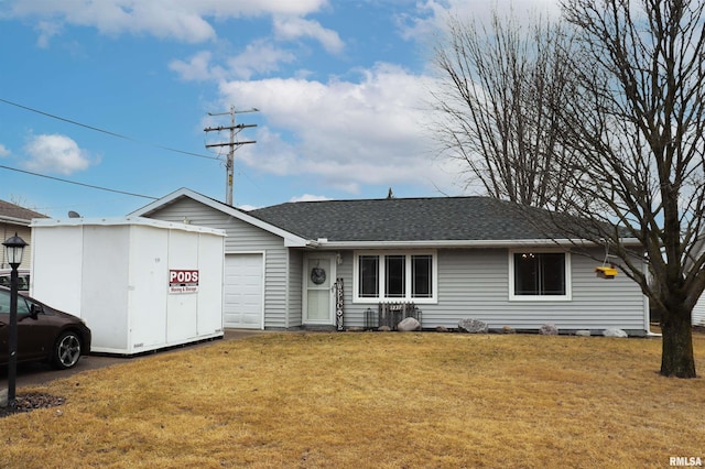 ranch-style home featuring a garage, a front lawn, and roof with shingles