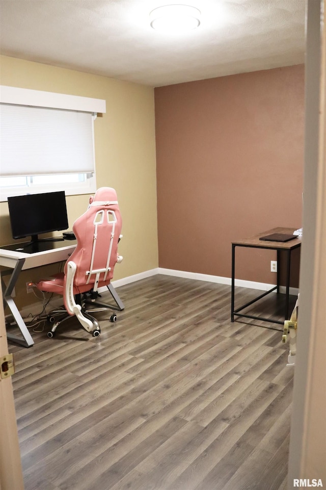 home office featuring baseboards and wood finished floors