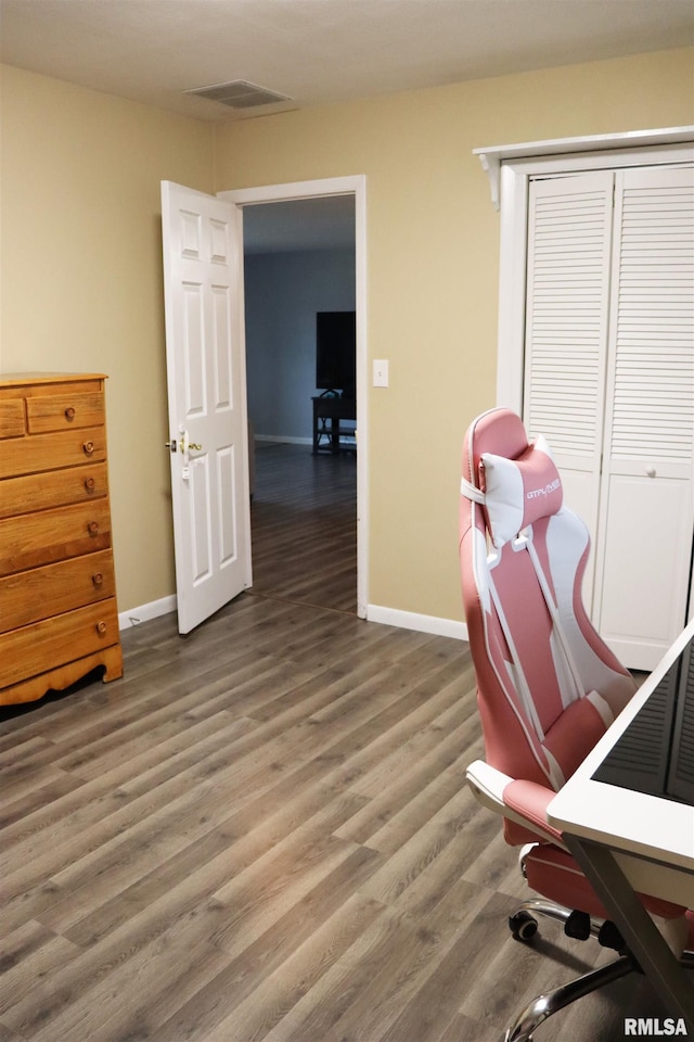 office space with baseboards, visible vents, and light wood finished floors