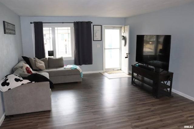 living room with baseboards and dark wood-type flooring