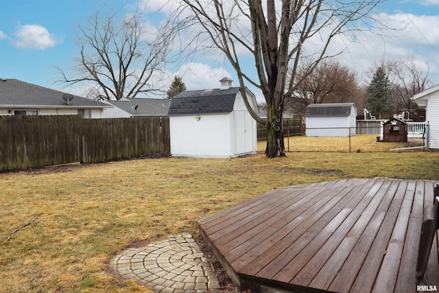 view of yard featuring an outbuilding, a shed, and a fenced backyard