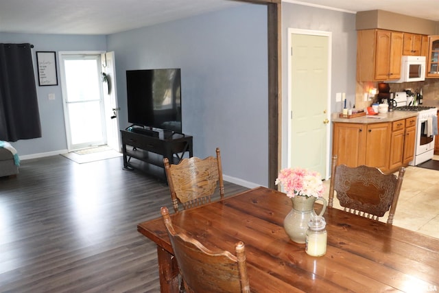 dining space with wood finished floors and baseboards