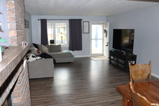 living area featuring baseboards and wood finished floors