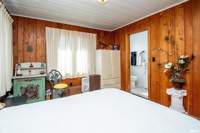 bedroom with ensuite bathroom and wooden walls