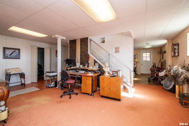 carpeted office space featuring a paneled ceiling