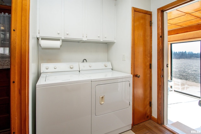 washroom with cabinet space and separate washer and dryer