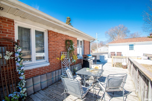 wooden deck featuring outdoor dining area and area for grilling