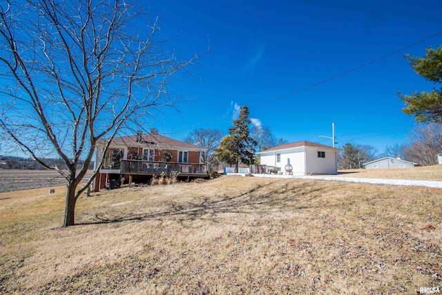 view of front facade with a front yard and a deck