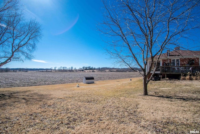 view of yard featuring a rural view and a deck