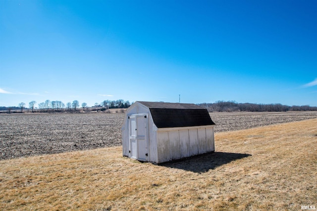 view of shed with a rural view