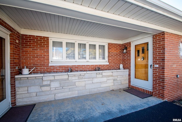 property entrance with brick siding