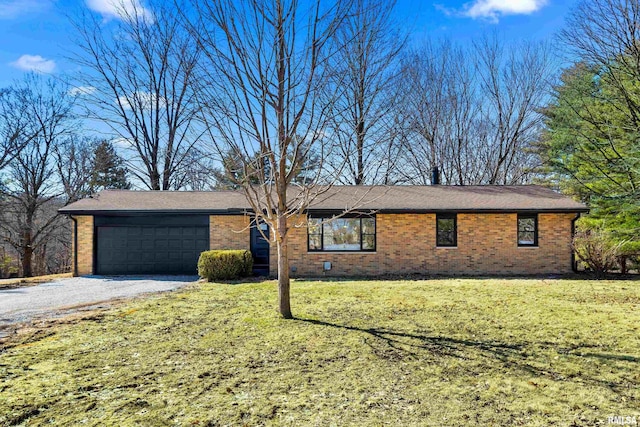 ranch-style house featuring a garage, brick siding, a front yard, and gravel driveway